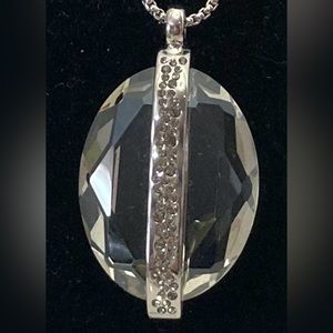 Clear pendant necklace with rhinestones on a silver tone chain. Gently worn.